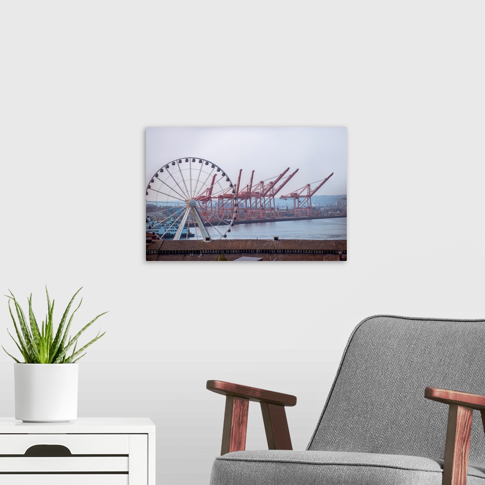A modern room featuring View of Seattle's giant Ferris wheel with dockside cranes in the background in Seattle, Washington.