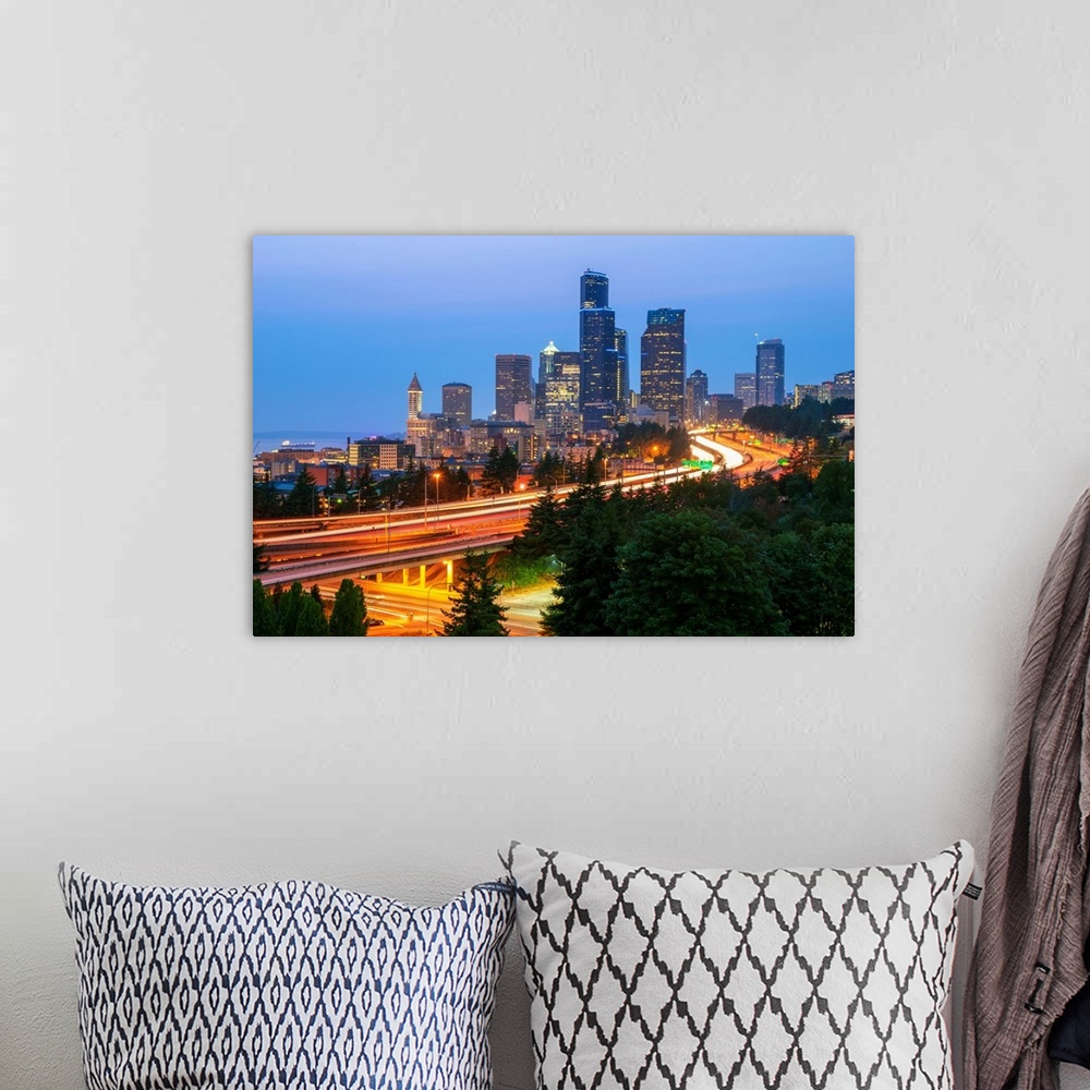 A bohemian room featuring Photograph of the Seattle skyline at dusk with light trails from the cars on the highway in the f...