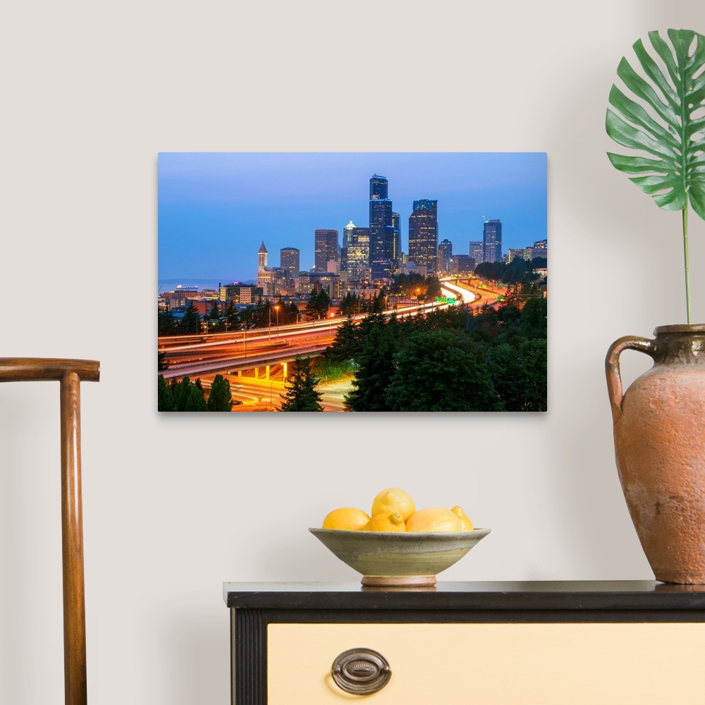 A traditional room featuring Photograph of the Seattle skyline at dusk with light trails from the cars on the highway in the f...