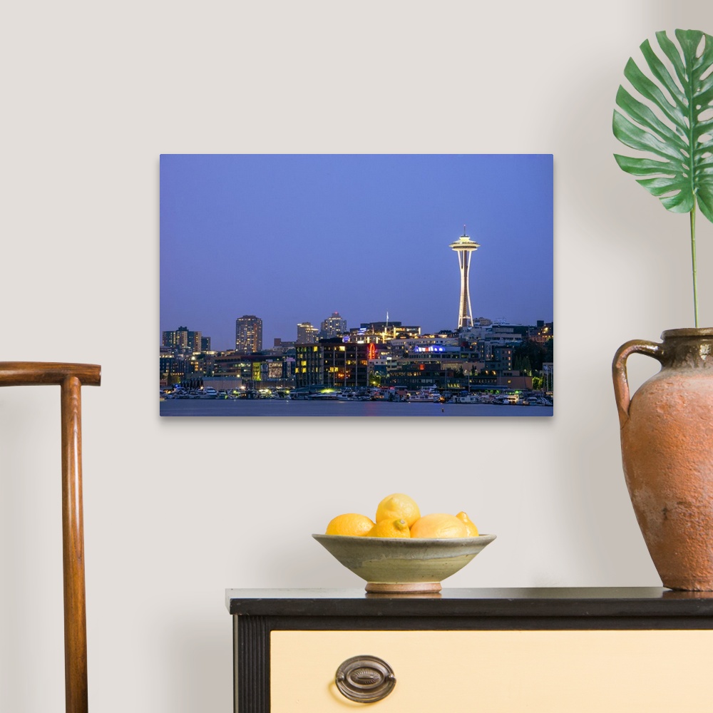 A traditional room featuring Photograph of the Seattle skyline lit up at night from the water.