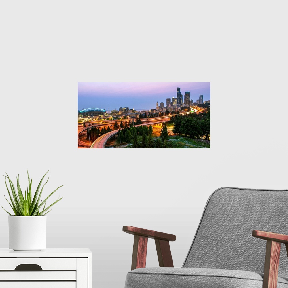 A modern room featuring Panoramic photograph of the Seattle skyline at night with light trails from the car lights on the...