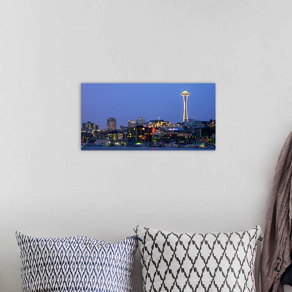 A bohemian room featuring Panoramic photograph of the Seattle skyline lit up at night from the water.