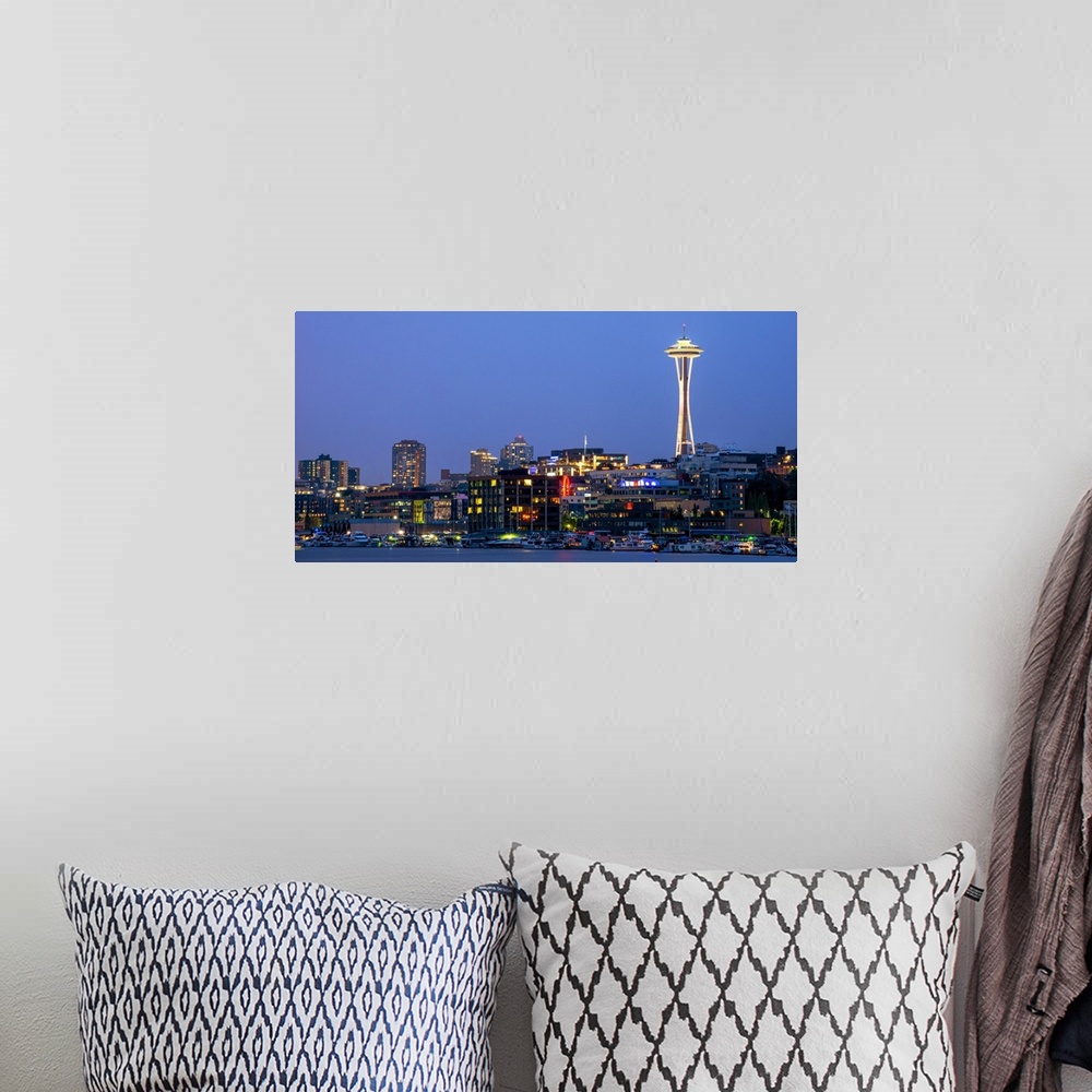 A bohemian room featuring Panoramic photograph of the Seattle skyline lit up at night from the water.