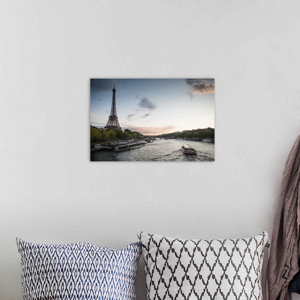 A bohemian room featuring Landscape photograph of the Seine River with the Eiffel Tower on the side.