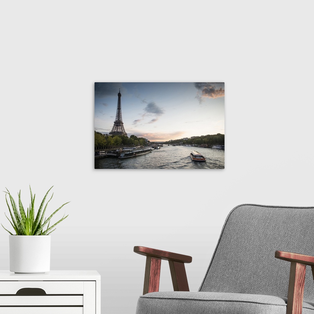 A modern room featuring Landscape photograph of the Seine River with the Eiffel Tower on the side.