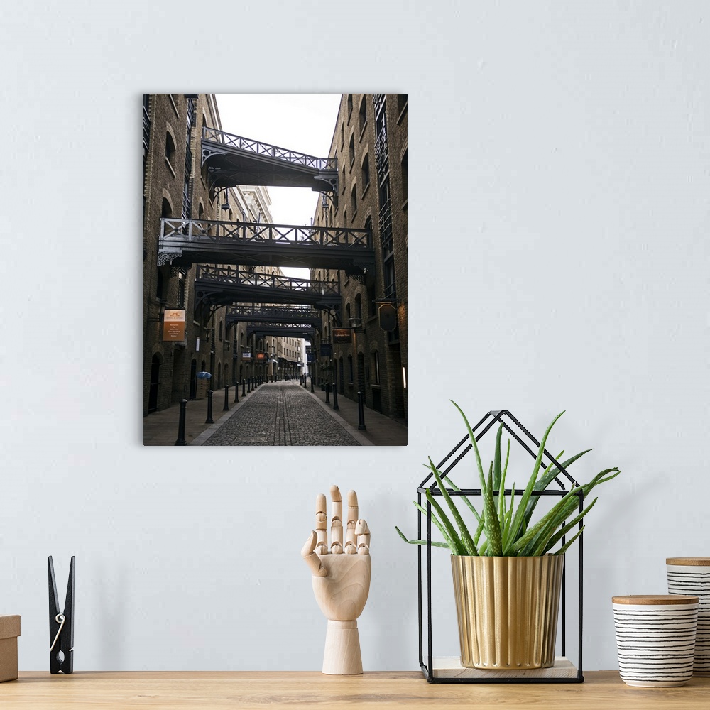 A bohemian room featuring Photograph of Shad Thames lined with warehouses and walkways alongside Tower Bridge in London.
