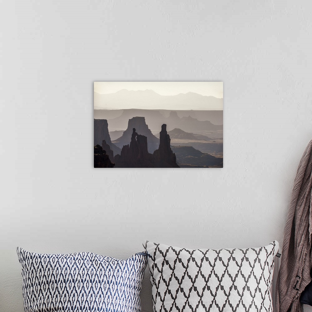 A bohemian room featuring Hazy morning light gives the eroded rock structures a soft blue hue in Canyonlands National Park,...