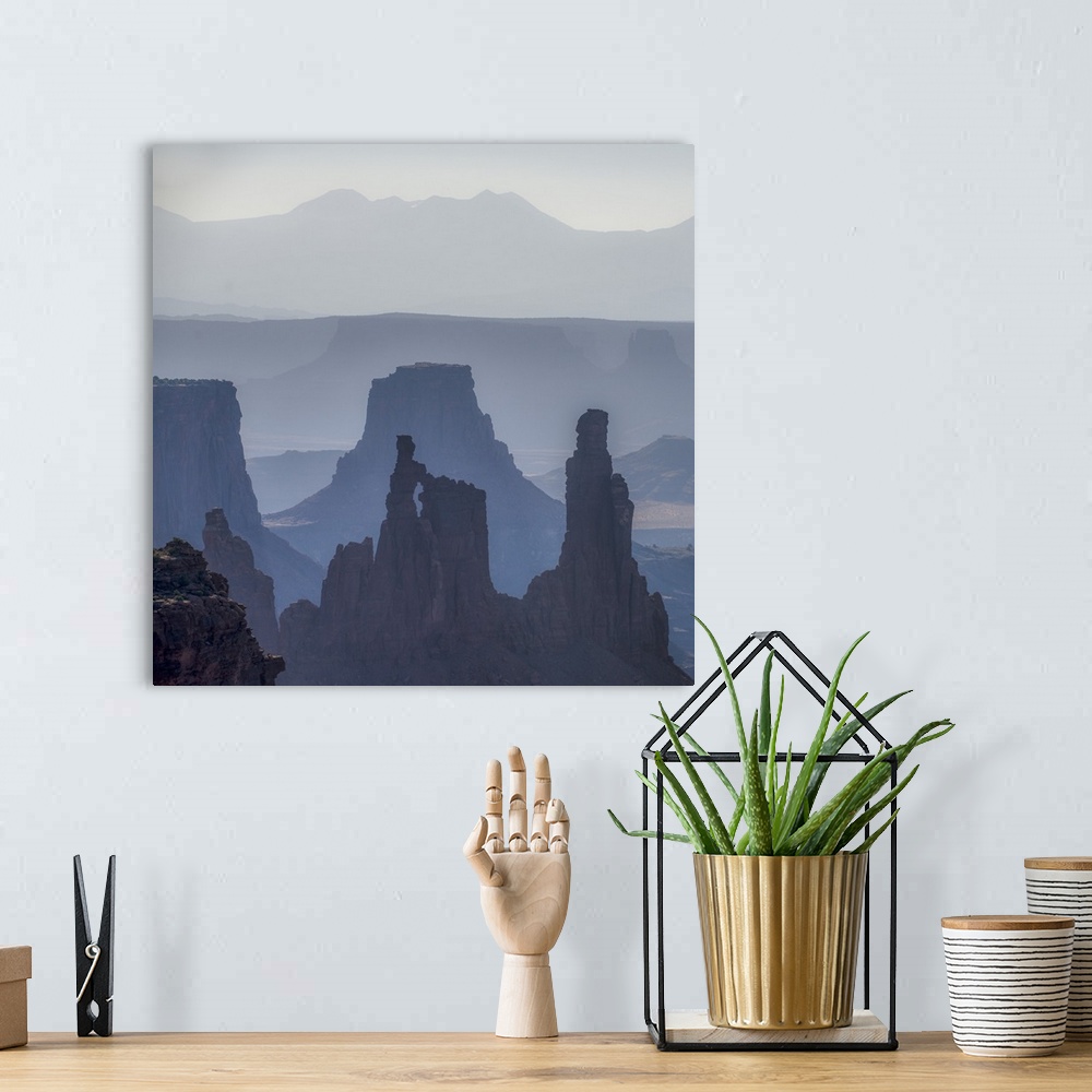A bohemian room featuring Hazy morning light gives the eroded rock structures a soft blue hue in Canyonlands National Park,...