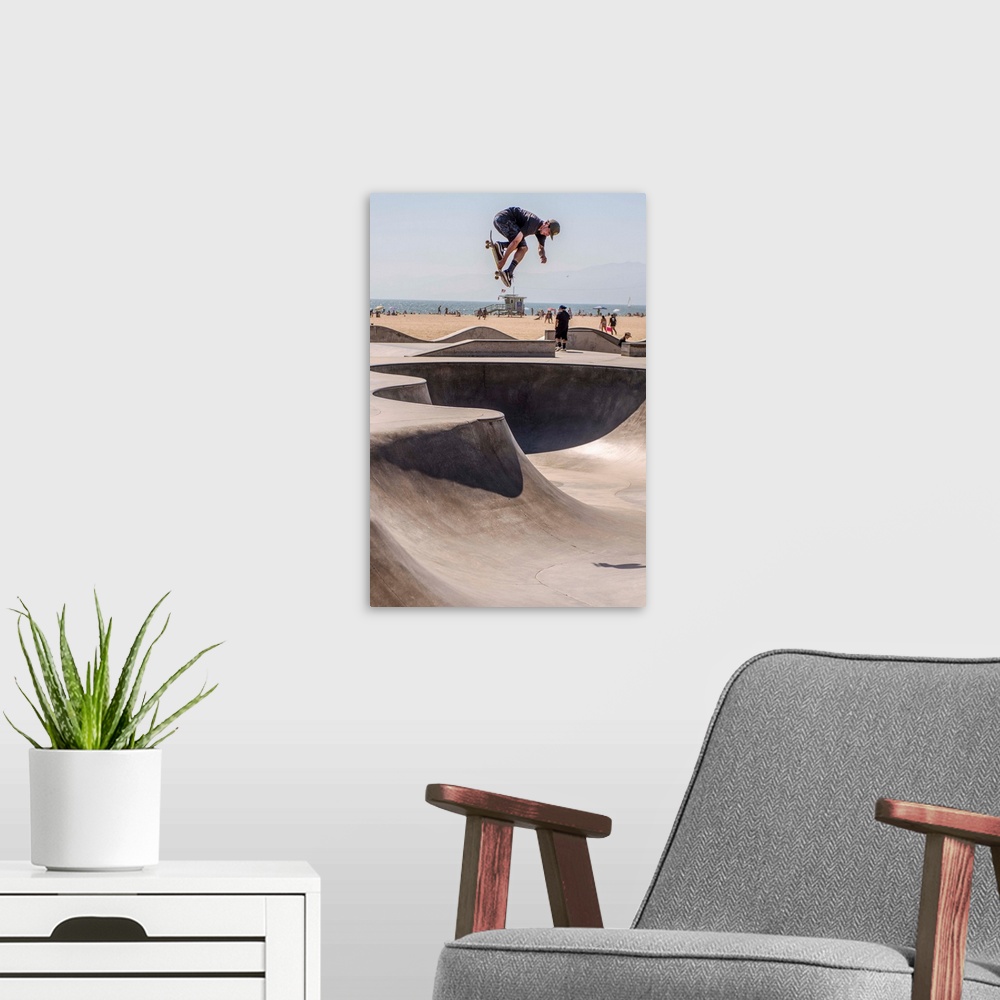 A modern room featuring A local skater is in mid-air at Venice's seaside skate park, Los Angeles.