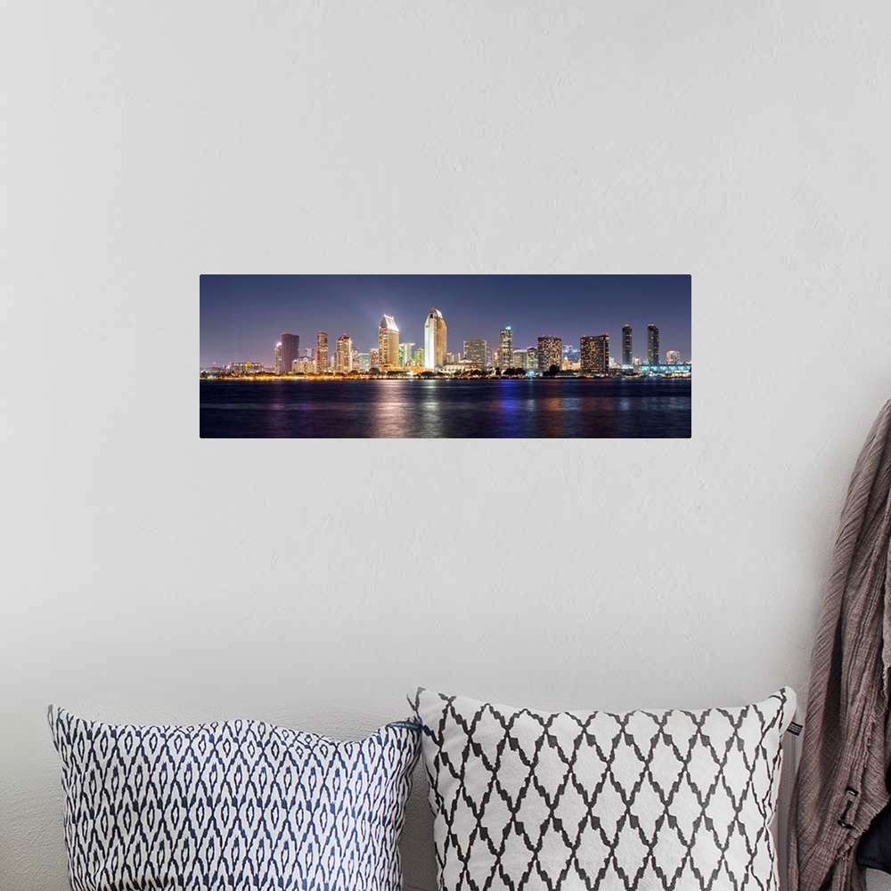 A bohemian room featuring Panoramic photograph of the San Diego, California skyline lit up at night from across the water.