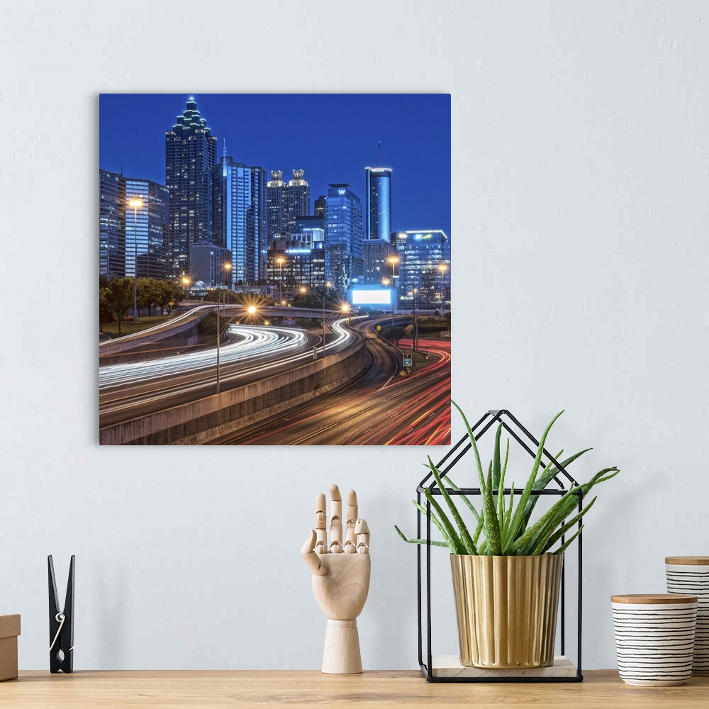 A bohemian room featuring City skyline of Atlanta, Georgia, illuminated night with light trails from passing traffic in the...