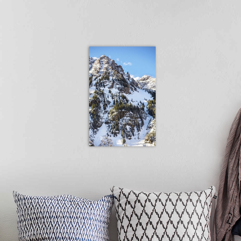 A bohemian room featuring Snow and pine trees on the mountainside under a blue sky, Maroon Bells, Colorado.