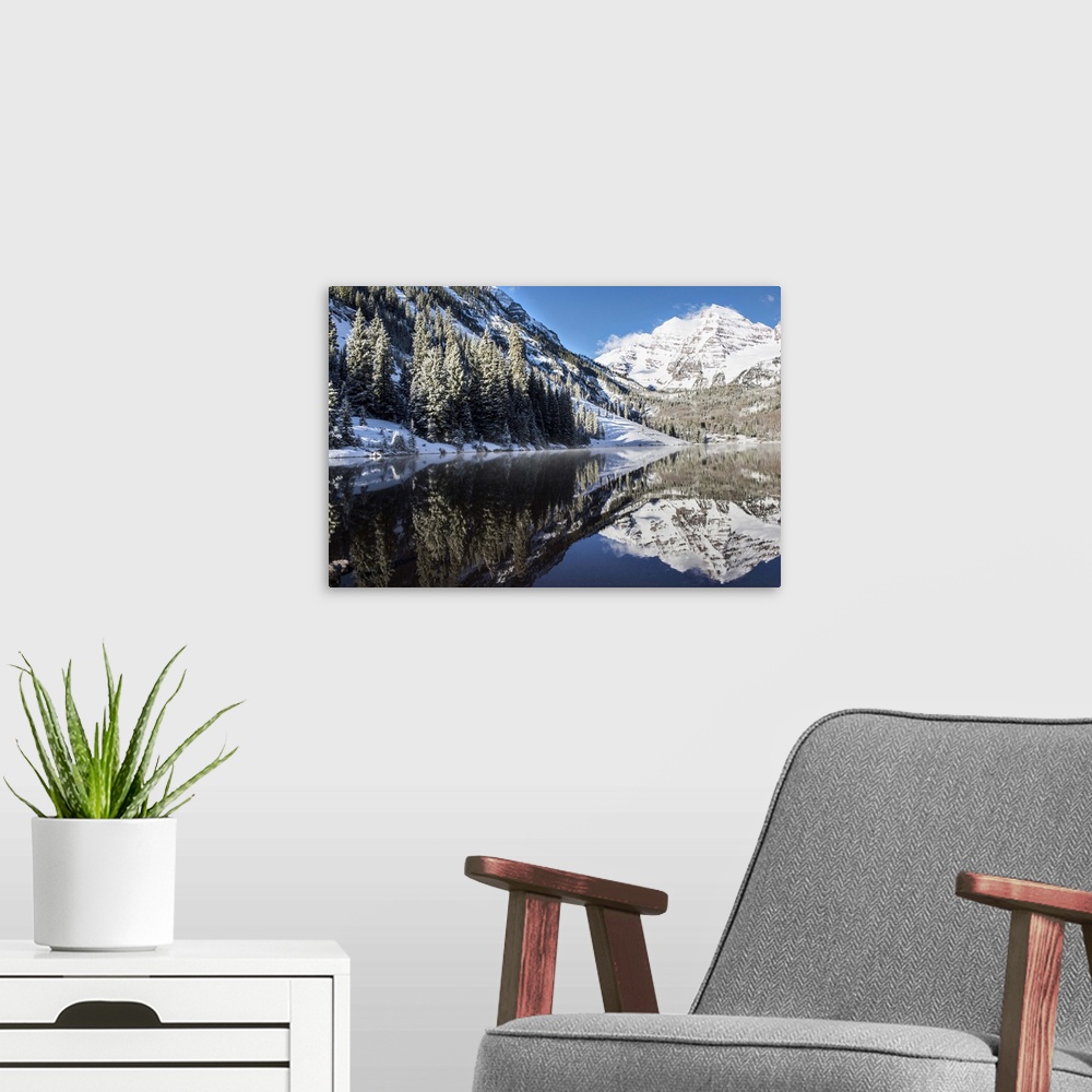 A modern room featuring Snowy peaks of the Maroon Bells mirrored perfectly in the waters of the Maroon Lake below, Aspen,...