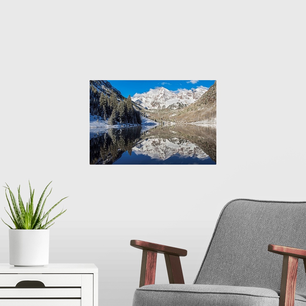 A modern room featuring Snowy peaks of the Maroon Bells mirrored perfectly in the waters of the Maroon Lake below, Aspen,...