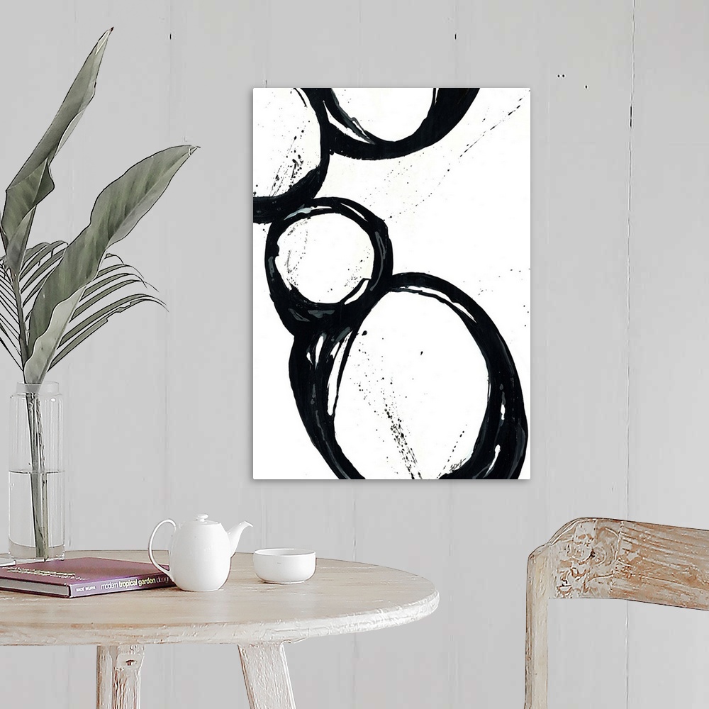 A farmhouse room featuring Large vertical abstract modern artwork of different sized circular designs on a blank background.