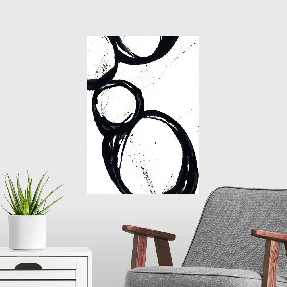 A modern room featuring Large vertical abstract modern artwork of different sized circular designs on a blank background.