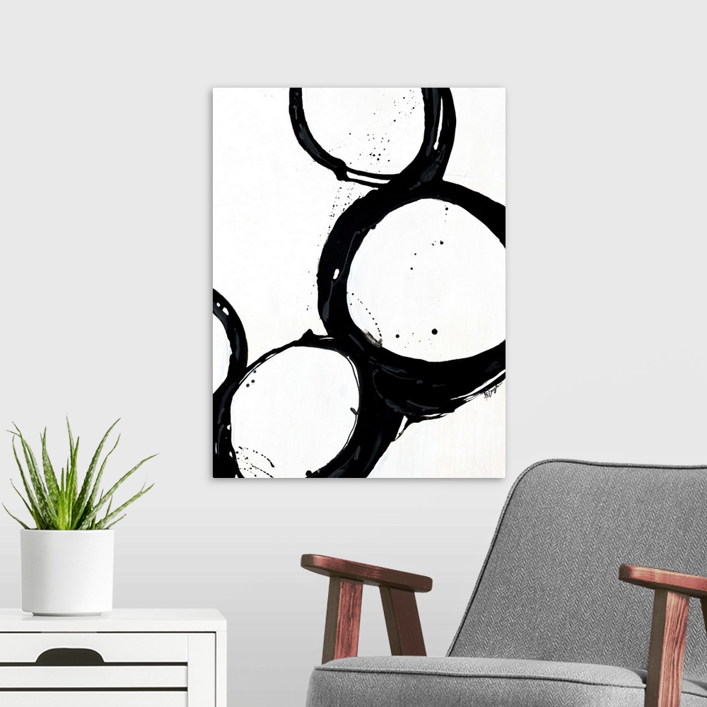 A modern room featuring Giant monochromatic abstract art includes a set of four uneven and irregular circles positioned n...