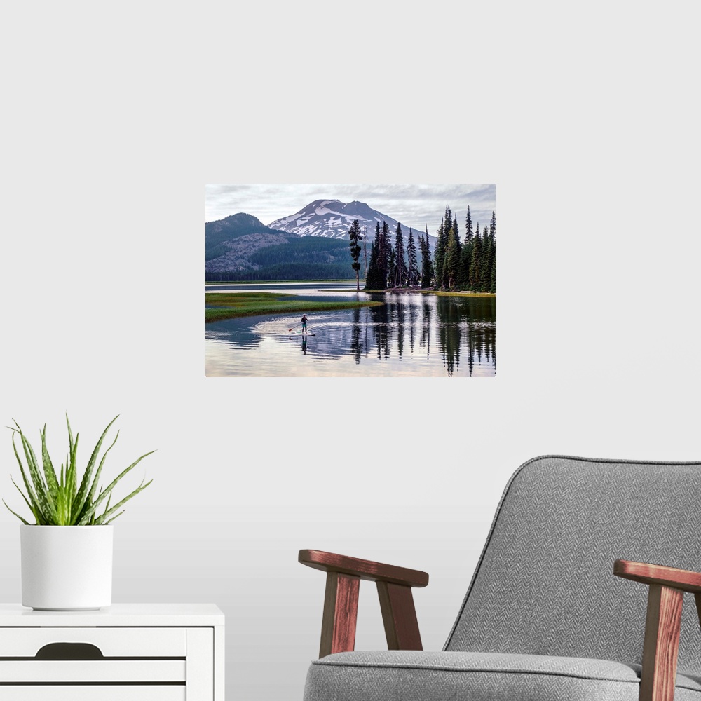 A modern room featuring View of a paddle board surfer at Sparks Lake with South Sister peak in the background, Deschutes ...
