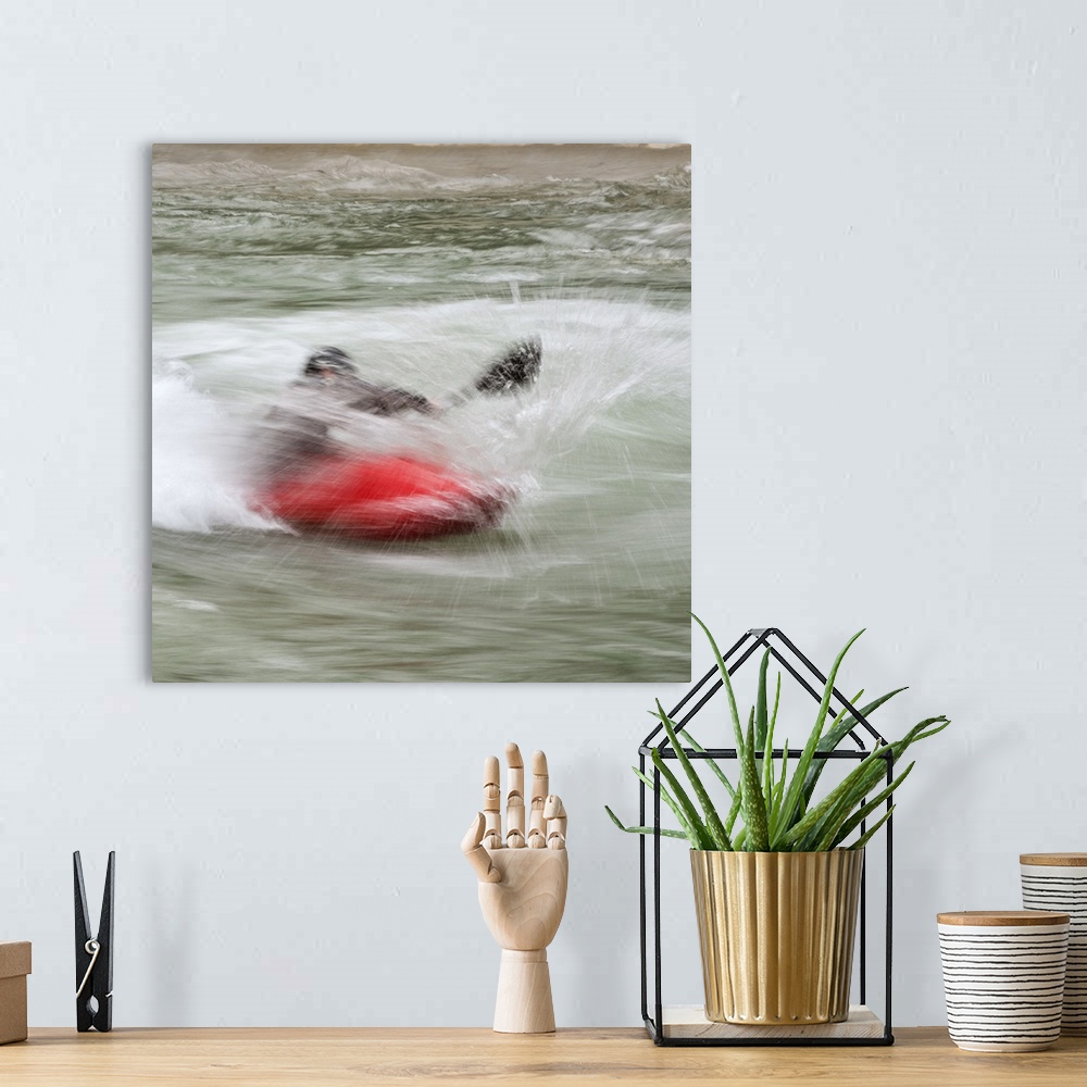 A bohemian room featuring A person paddling in a kayak in whitewater rapids.