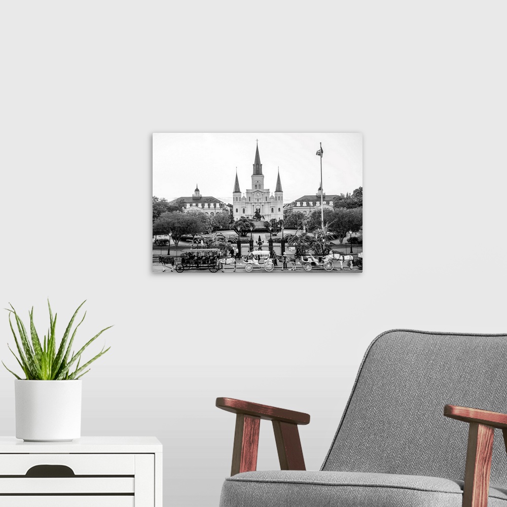 A modern room featuring View of carriages stand in front of St. Louis Cathedral and Jackson Square in New Orleans, Louisi...