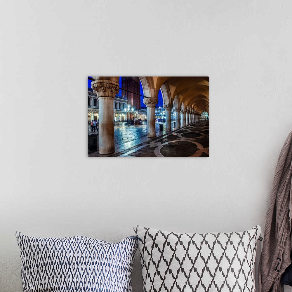 A bohemian room featuring Photograph of the view from underneath arches at night in St. Mark's Square, Venice.