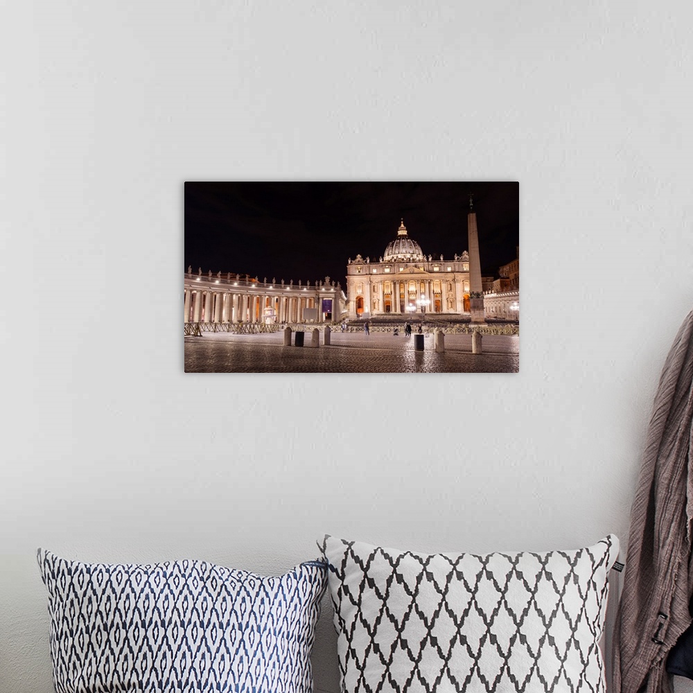 A bohemian room featuring Photograph of St. Peter's Basilica at St. Peter's Square in Vatican City at night.