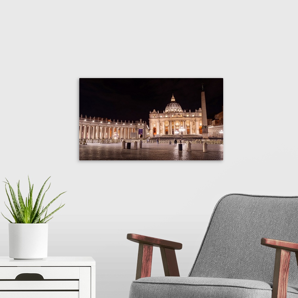A modern room featuring Photograph of St. Peter's Basilica at St. Peter's Square in Vatican City at night.