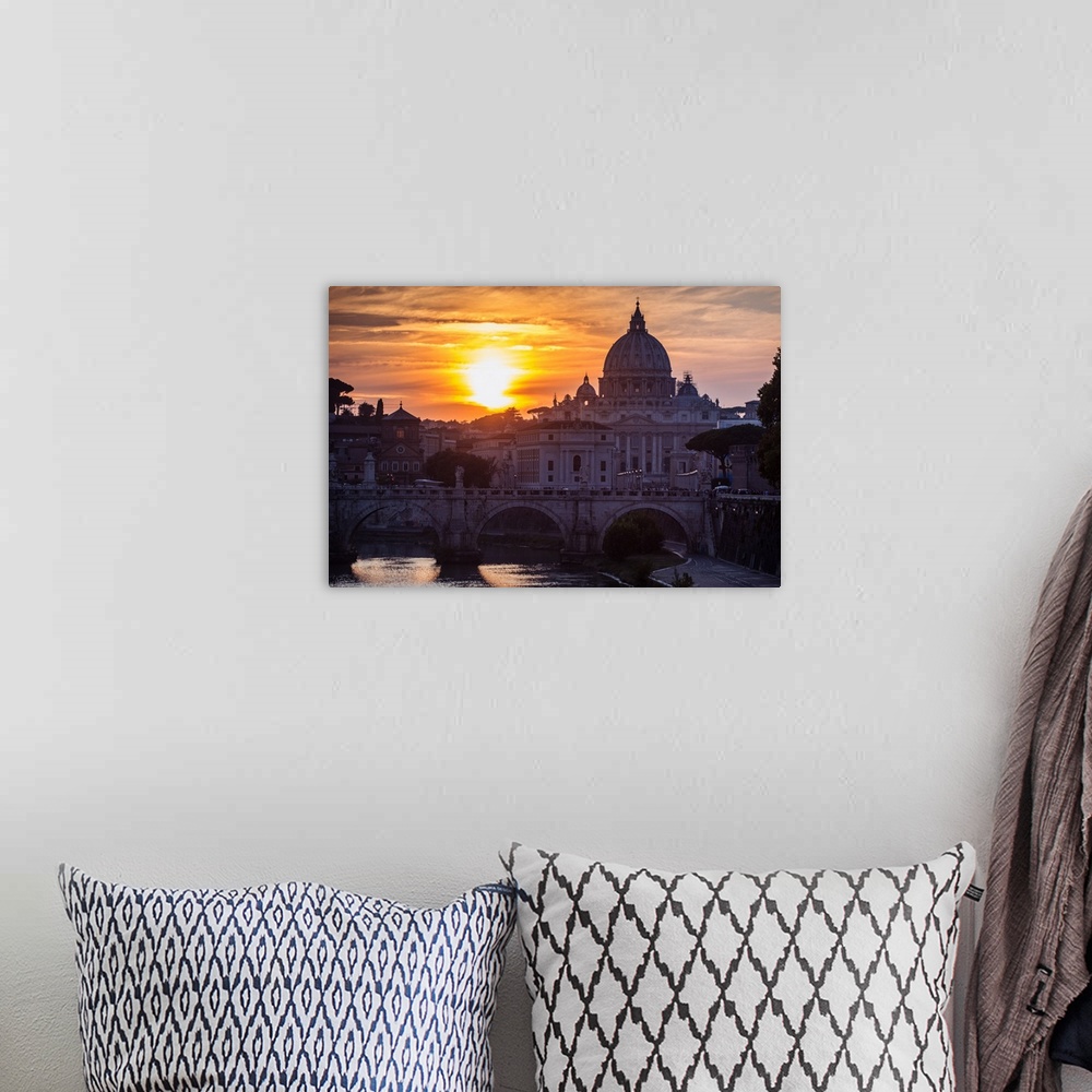 A bohemian room featuring Photograph of St. Peter's Basilica with Ponte Sant'Angelo over the river Tober at sunset.