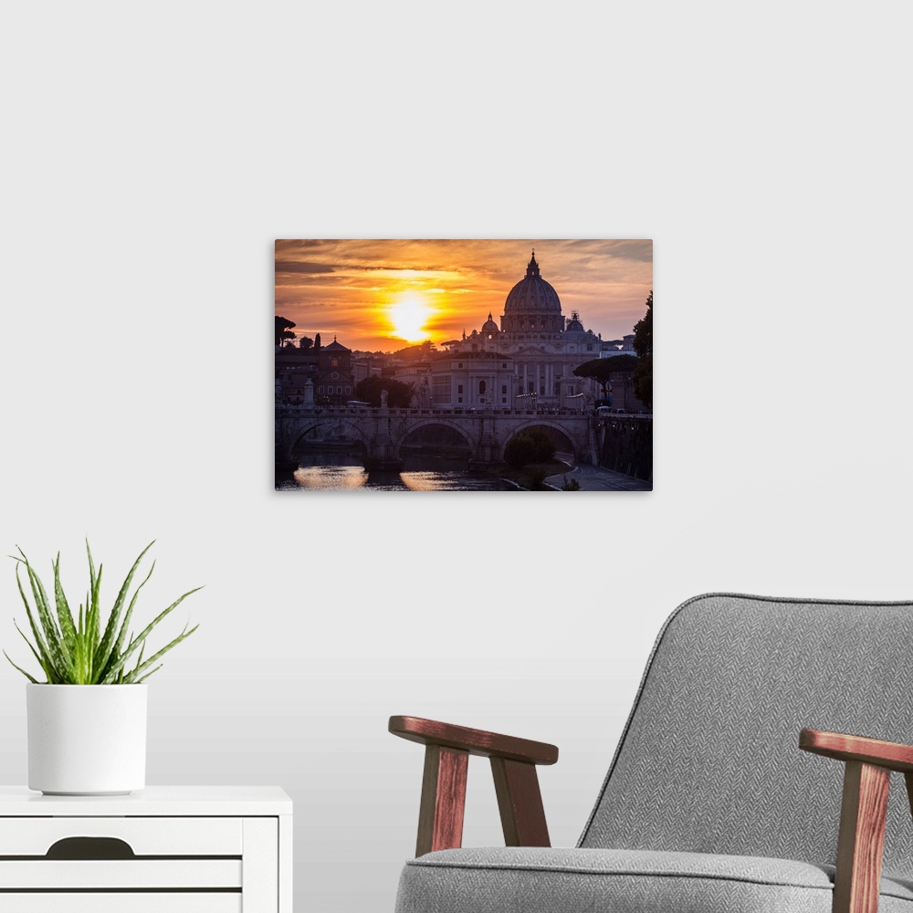 A modern room featuring Photograph of St. Peter's Basilica with Ponte Sant'Angelo over the river Tober at sunset.