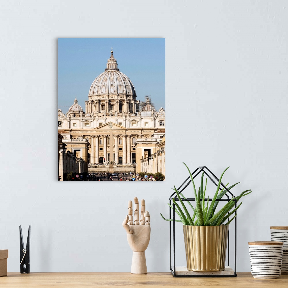 A bohemian room featuring Photograph of St. Peter's Basilica in Vatican City with the sun shining on it.