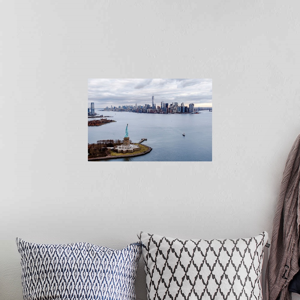 A bohemian room featuring Aerial view of the Statue of Liberty on Liberty Island with the New York City skyline in the dist...