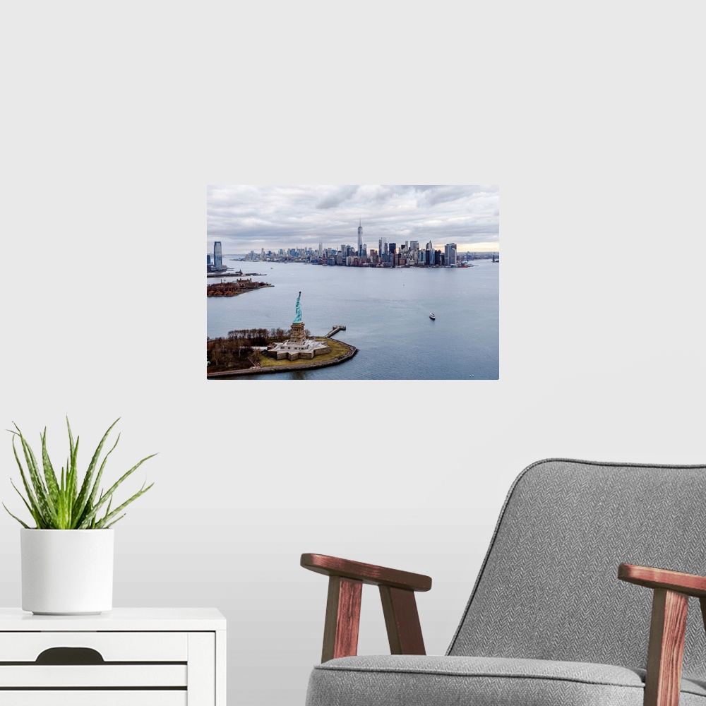 A modern room featuring Aerial view of the Statue of Liberty on Liberty Island with the New York City skyline in the dist...