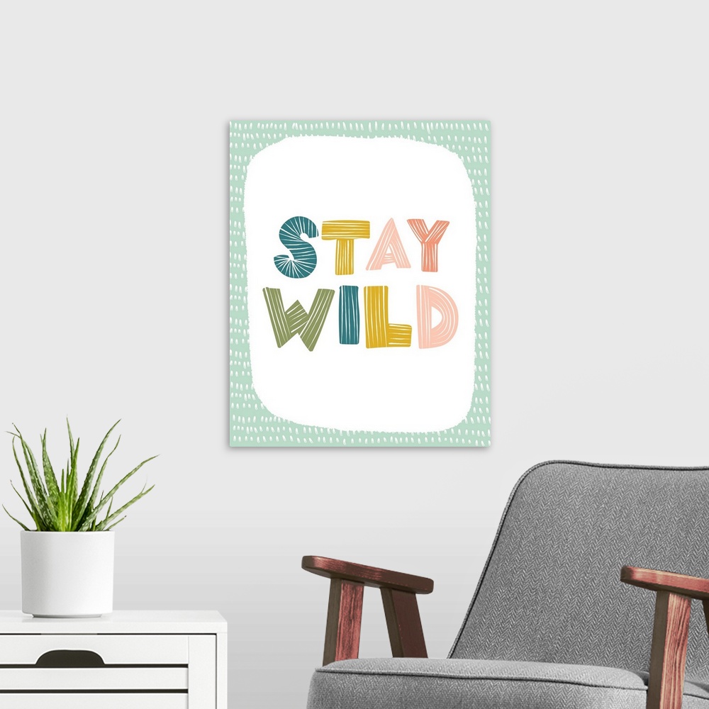 A modern room featuring Typography artwork with the words, "Stay Wild".