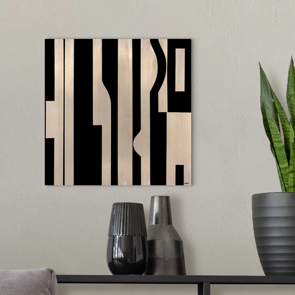 A modern room featuring Modern artwork featuring a mixture of dark and light colored shapes.
