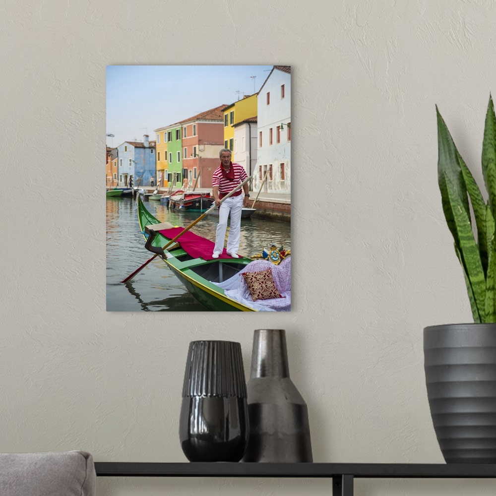 A modern room featuring Photograph of a gondolier wearing a red and white striped shirt, rowing through a canal lined wit...