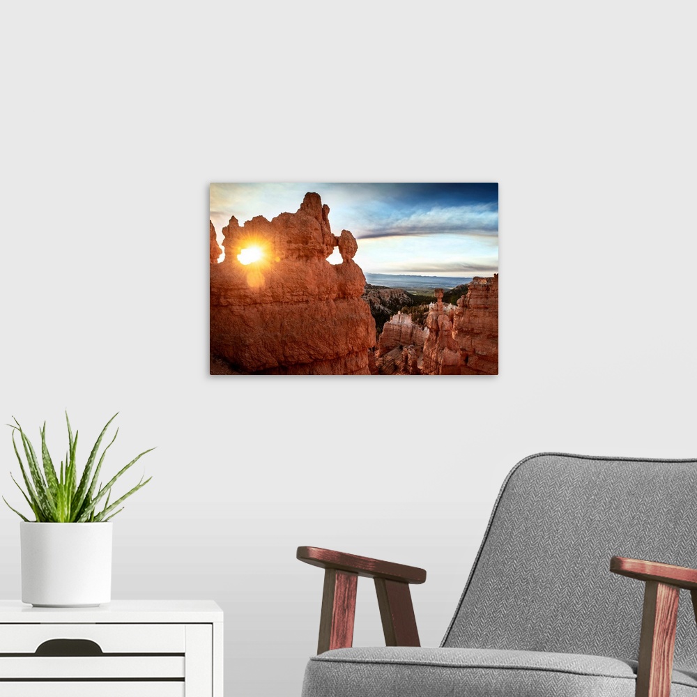 A modern room featuring The sun shining through a naturally eroded hole in a hoodoo formation in Bryce Canyon National Pa...