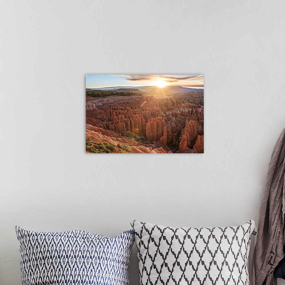A bohemian room featuring The sun on the horizon, seen from Bryce Canyon Amphitheater in Bryce Canyon National Park, Utah.