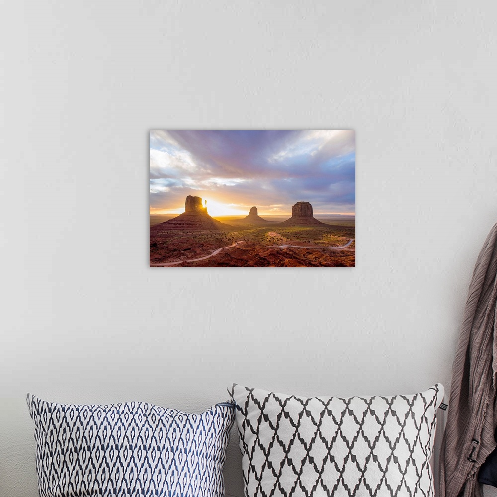 A bohemian room featuring Sunrise at the Mittens and Merrick Buttes in Monument Valley, Arizona.