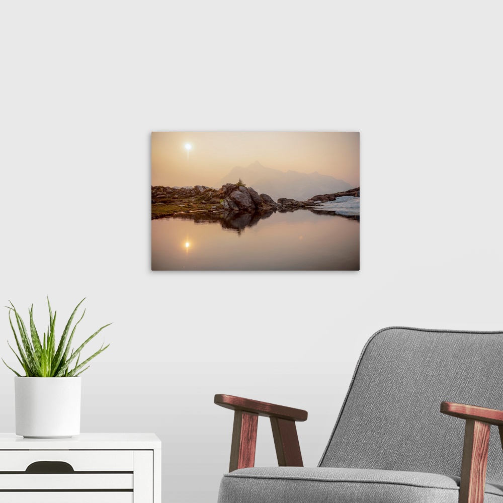 A modern room featuring The sun rises over Mount Shuksan on a foggy day with a pond on Artist Point Trail, Washington.