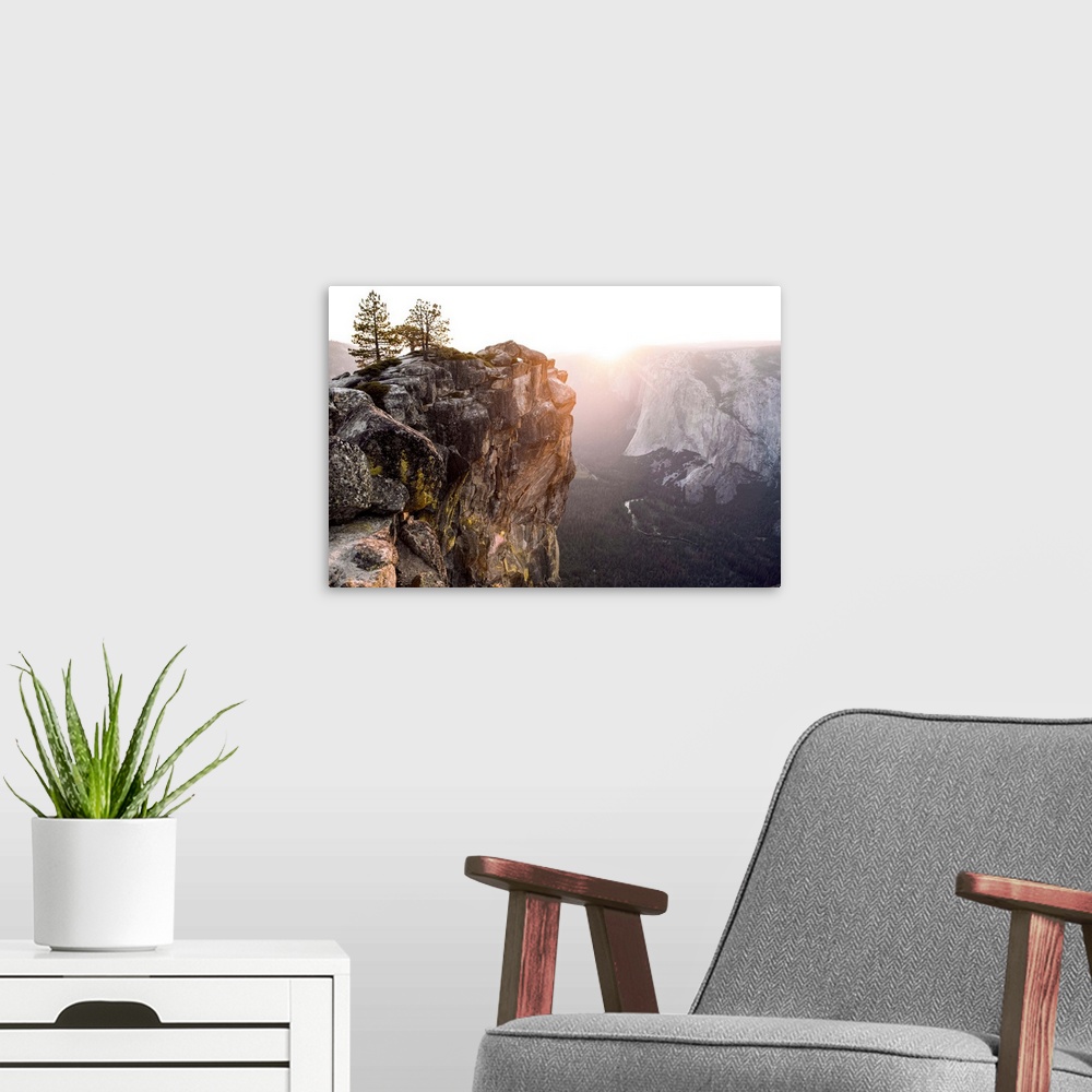 A modern room featuring The sun sets on a mountain landscape in Yosemite National Park, California.