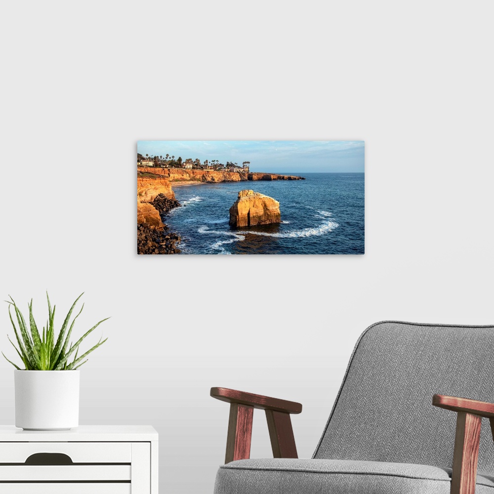 A modern room featuring The sun sets on a lone boulder in San Diego. The Sunset Cliffs are known for their picturesque la...