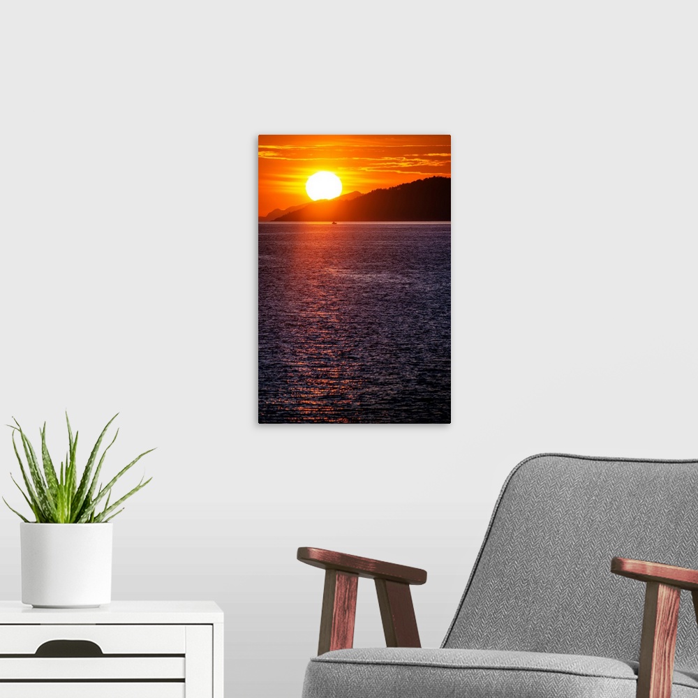 A modern room featuring The sun sets on Burrard Inlet near Vancouver in British Columbia, Canada.