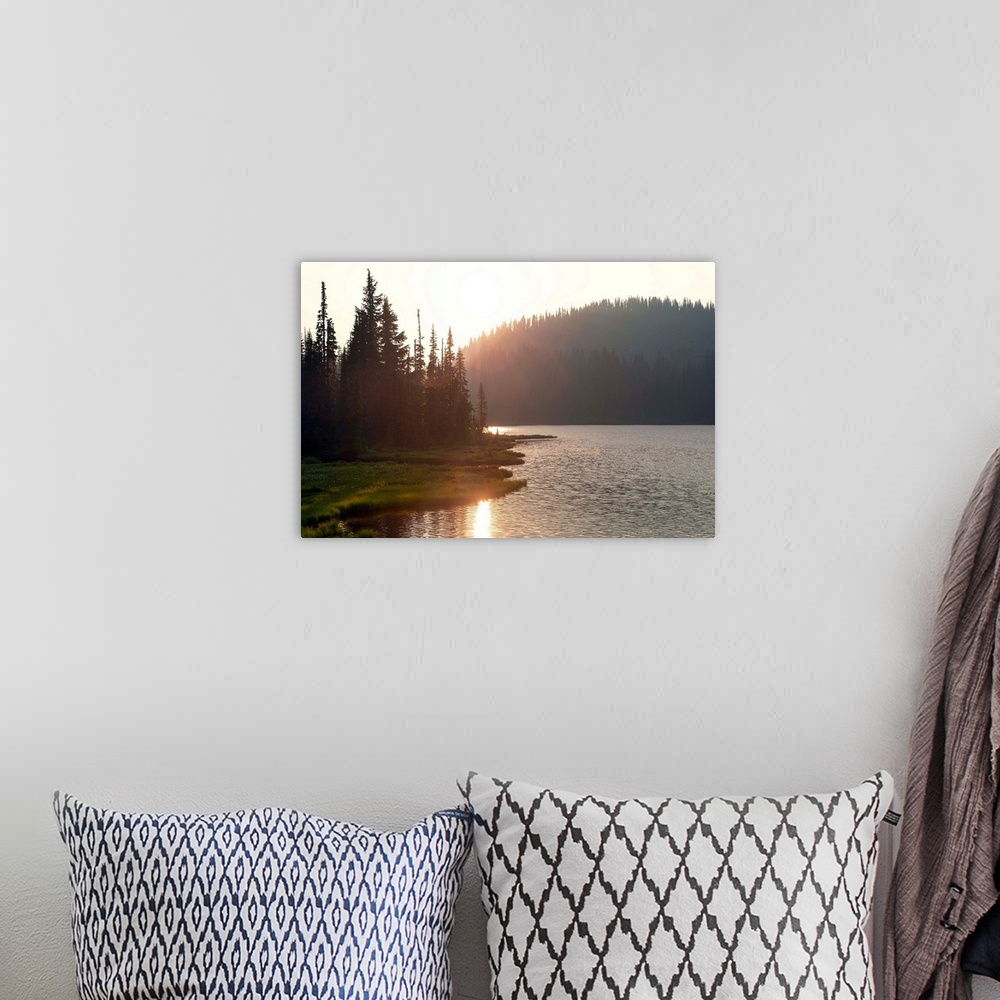 A bohemian room featuring The sun sets on a lake in Mount Rainier National Park, Washington.