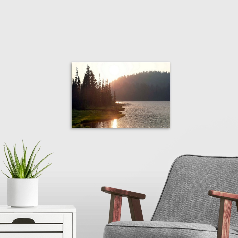 A modern room featuring The sun sets on a lake in Mount Rainier National Park, Washington.