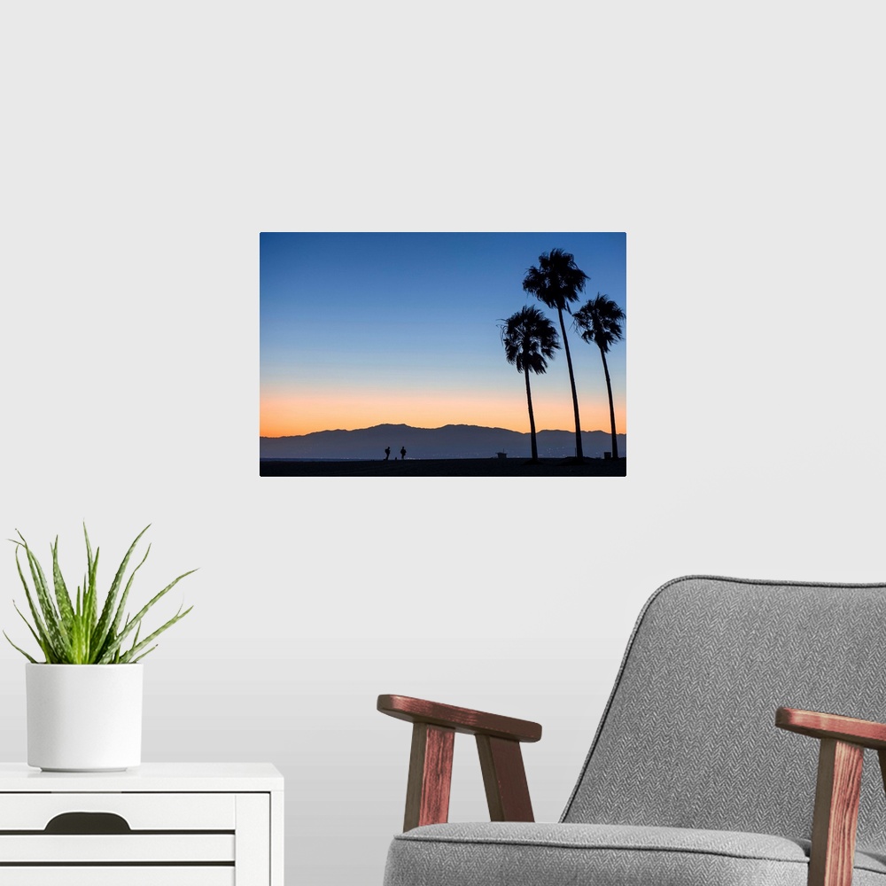 A modern room featuring The sun sets on Venice beach with the San Gabriel mountains in the background.
