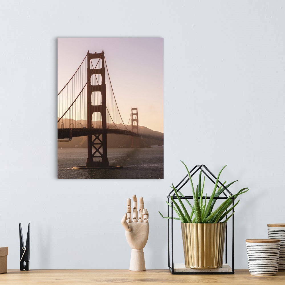 A bohemian room featuring Photograph of the Golden Gate Bridge with warm hues from the sunset and light fog.