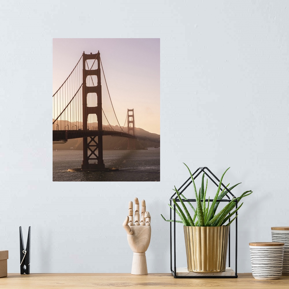 A bohemian room featuring Photograph of the Golden Gate Bridge with warm hues from the sunset and light fog.