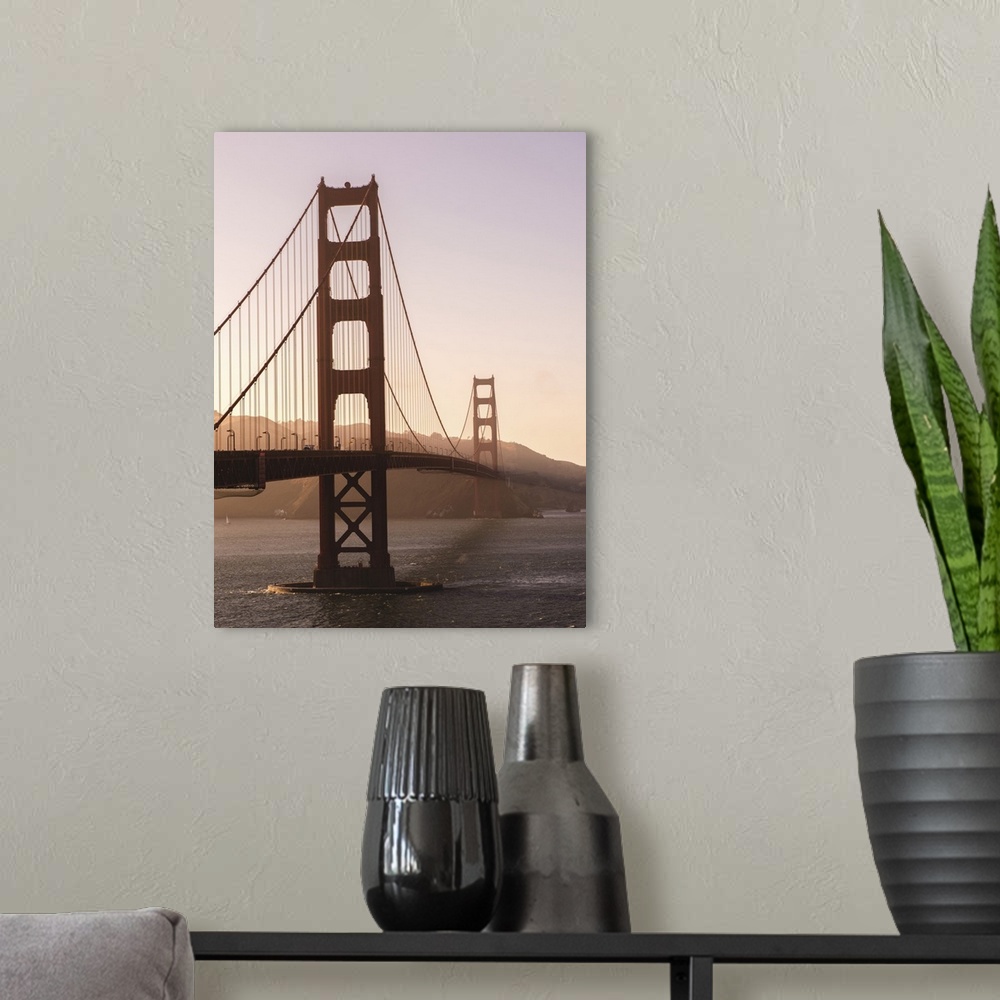 A modern room featuring Photograph of the Golden Gate Bridge with warm hues from the sunset and light fog.