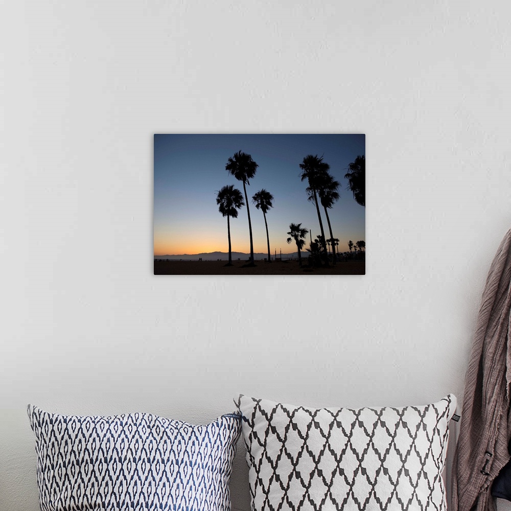 A bohemian room featuring The sun begins to set on Venice beach in California.