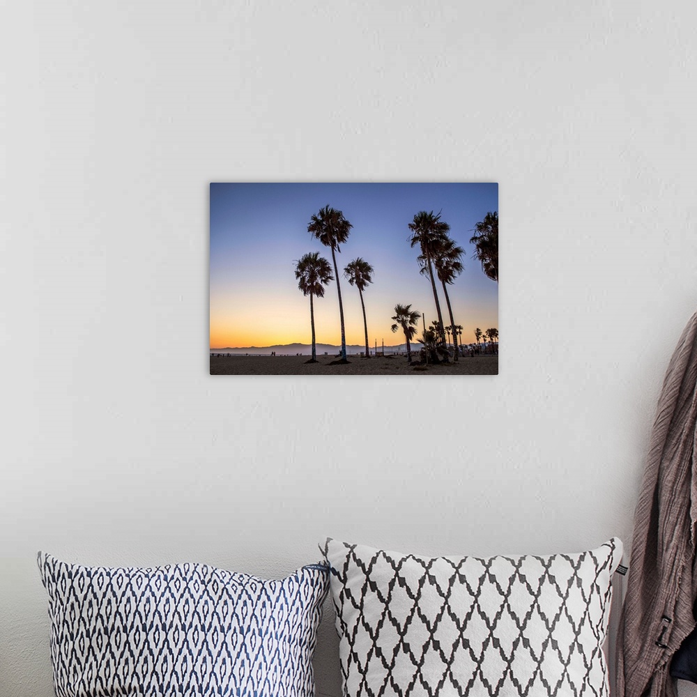 A bohemian room featuring The sun begins to set on Venice beach in California.